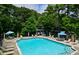 Community pool with plenty of chairs, tables, and umbrellas at 86 De Arc Nw Pl, Atlanta, GA 30327