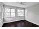 Bright sun room with dark wood floors, multiple windows, and a white door at 86 De Arc Nw Pl, Atlanta, GA 30327