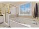 Bathroom featuring a glass enclosed shower and a large soaking tub with tile accents at 1647 Club Vista Trce, Stone Mountain, GA 30088