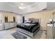 Bright bedroom with a large bed, gray carpeting, dresser and large windows allowing natural light at 1647 Club Vista Trce, Stone Mountain, GA 30088