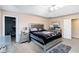Lovely bedroom with gray carpet, a bed with silver accents, and a glimpse into a closet at 1647 Club Vista Trce, Stone Mountain, GA 30088