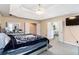 Spacious bedroom featuring a tray ceiling, neutral walls, plush carpet and an ensuite bathroom at 1647 Club Vista Trce, Stone Mountain, GA 30088
