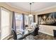 Bright dining area featuring a glass table set, modern decor, and large windows at 1647 Club Vista Trce, Stone Mountain, GA 30088