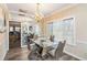 Elegant dining room with mirrored wall, chandelier, and modern glass-top table at 1647 Club Vista Trce, Stone Mountain, GA 30088