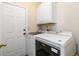 Functional laundry room with white cabinetry, washer, and dryer units at 1647 Club Vista Trce, Stone Mountain, GA 30088