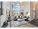 Bright living room with large windows, hardwood floors, and stylish furniture at 1647 Club Vista Trce, Stone Mountain, GA 30088