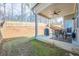 Spacious backyard with covered patio, grill, and a dining set that is enclosed by a wooden fence at 614 Denali Dr, Mableton, GA 30126
