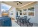 A covered patio with a grill and outdoor dining set offers a relaxing view of the backyard at 614 Denali Dr, Mableton, GA 30126