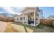 View of the backyard with a covered patio, grill and dining table, and a wood fence at 614 Denali Dr, Mableton, GA 30126