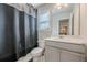 Bathroom features a toilet, vanity with sink, large mirror and stylish gray shower curtain at 614 Denali Dr, Mableton, GA 30126