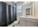 Well-lit bathroom featuring a modern vanity, toilet, and shower with a curtain at 614 Denali Dr, Mableton, GA 30126