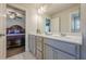 Bathroom with double vanity and view into bedroom with hardwood floors at 614 Denali Dr, Mableton, GA 30126