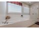 This stunning bathroom features a glass shower, soaking tub, and modern finishes at 614 Denali Dr, Mableton, GA 30126