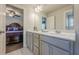 Bathroom with double vanity and view into bedroom with hardwood floors at 614 Denali Dr, Mableton, GA 30126