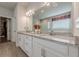 Double sink vanity with granite countertops and a view of the glass enclosed shower at 614 Denali Dr, Mableton, GA 30126