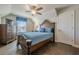 Comfortable bedroom featuring hardwood floors, a comfortable bed, dresser with a TV, and a window with blind coverings at 614 Denali Dr, Mableton, GA 30126