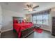 Bright bedroom with a large window, featuring a wood bed frame and hardwood flooring at 614 Denali Dr, Mableton, GA 30126