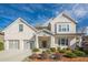 Charming two-story brick home featuring a three-car garage and a well-manicured front lawn with a long driveway at 614 Denali Dr, Mableton, GA 30126