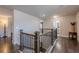 Upstairs hallway features hardwood floors and wooden railings at 614 Denali Dr, Mableton, GA 30126