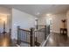 Upstairs hallway features hardwood floors and wooden railings at 614 Denali Dr, Mableton, GA 30126