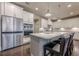 Bright kitchen with island, stainless fridge, and barstool seating at 614 Denali Dr, Mableton, GA 30126
