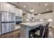 Bright kitchen with island, stainless fridge, and barstool seating at 614 Denali Dr, Mableton, GA 30126