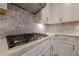 Modern kitchen features a gas range and gray backsplash at 614 Denali Dr, Mableton, GA 30126