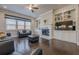 Bright living room featuring a fireplace, built-in shelving, and hardwood floors at 614 Denali Dr, Mableton, GA 30126