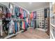 Organized walk-in closet with custom shelving, hanging rods, and wood floors at 614 Denali Dr, Mableton, GA 30126