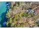 Expansive waterfront property on a serene lake, surrounded by lush greenery and mature trees at 7530 Heard Rd, Cumming, GA 30041