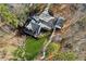 Aerial view of a home with a long driveway, expansive lawn and deck with patio furniture at 7530 Heard Rd, Cumming, GA 30041