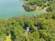 Beautiful lakefront home nestled in mature trees with access to pristine waters and lush surroundings at 7530 Heard Rd, Cumming, GA 30041