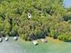 Expansive lakefront property featuring a home nestled among lush trees with private docks along the serene waterfront at 7530 Heard Rd, Cumming, GA 30041