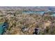 Breathtaking aerial view of the lakefront home nestled in a serene wooded setting at 7530 Heard Rd, Cumming, GA 30041