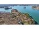 Beautiful aerial view of a lake with waterfront homes nestled among lush trees and greenery at 7530 Heard Rd, Cumming, GA 30041