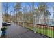 Expansive deck with seating, overlooking a lush yard and the serene lake, perfect for outdoor relaxation at 7530 Heard Rd, Cumming, GA 30041