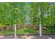 Scenic view from deck overlooking grassy backyard leading to lake at 7530 Heard Rd, Cumming, GA 30041