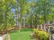 Lush backyard with access to the lake featuring a deck, landscaping, and scenic views at 7530 Heard Rd, Cumming, GA 30041