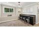 Basement bar featuring sleek cabinets, granite countertop, stainless steel stools, and decor at 7530 Heard Rd, Cumming, GA 30041