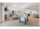 Open basement with fireplace, bar, living area, and dining space at 7530 Heard Rd, Cumming, GA 30041