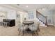Finished basement area with a bar, game table, and stairs to the upper level at 7530 Heard Rd, Cumming, GA 30041