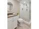 Modern bathroom with a glass-enclosed shower, neutral tile, and a sleek white vanity at 7530 Heard Rd, Cumming, GA 30041