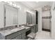 Modern bathroom featuring double vanity with marble counters, elegant fixtures, and glass enclosed shower at 7530 Heard Rd, Cumming, GA 30041