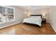 Bright bedroom with hardwood floors, a large window, and neutral walls at 7530 Heard Rd, Cumming, GA 30041