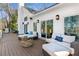 Inviting deck features ample seating, a stone fire pit, and scenic views, perfect for relaxing and entertaining outdoors at 7530 Heard Rd, Cumming, GA 30041