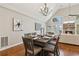 Dining area with chandelier, table seating for six, and scenic views of the outdoor landscape at 7530 Heard Rd, Cumming, GA 30041