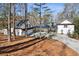Charming white home featuring a covered carport, lush green landscaping and a driveway at 7530 Heard Rd, Cumming, GA 30041