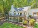 Stunning home exterior with a large deck, landscaped yard, and beautiful outdoor living spaces at 7530 Heard Rd, Cumming, GA 30041