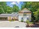 Beautiful two-story home featuring white siding, black trim, and a drive-through portico connecting the house and garage at 7530 Heard Rd, Cumming, GA 30041