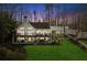Beautiful two-story home with a spacious deck, manicured lawn, and lush trees at 7530 Heard Rd, Cumming, GA 30041